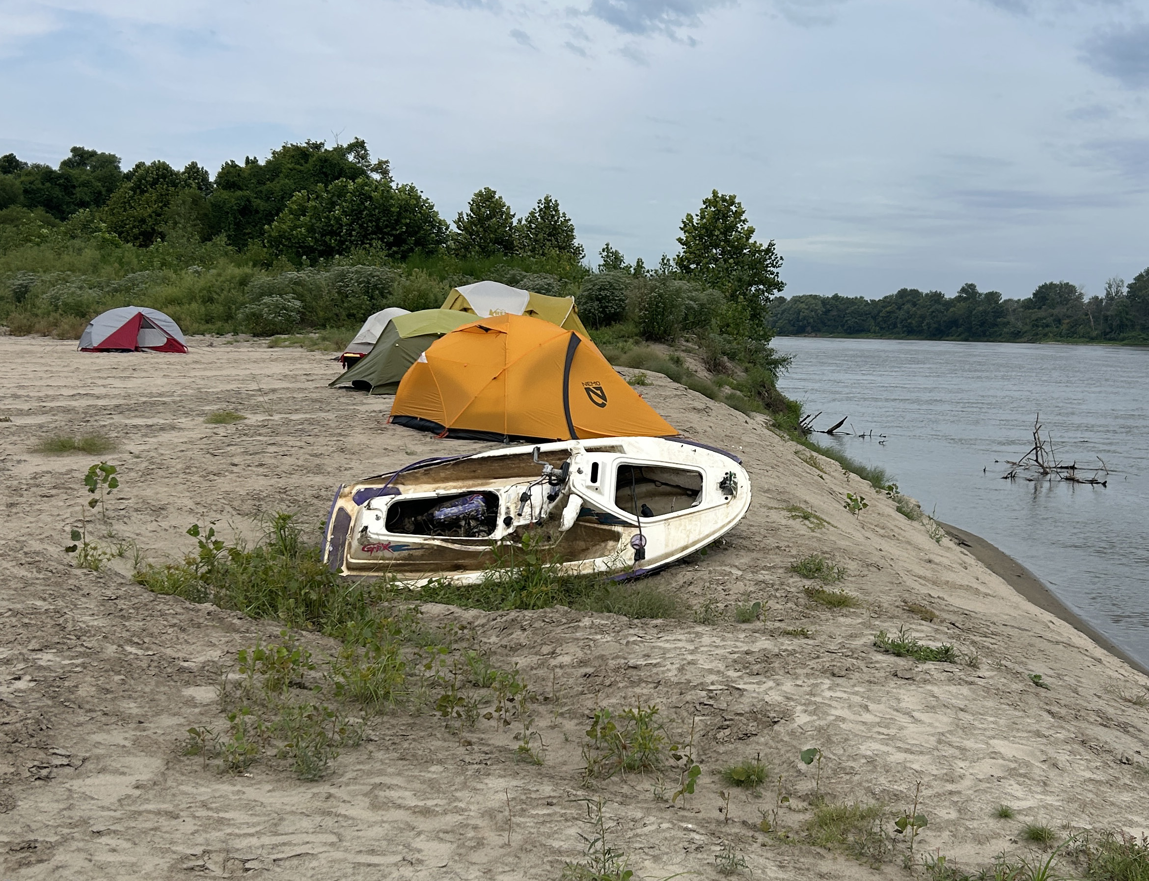 A damaged WaveRunner on the sand beside the Missouri River cleanup camp